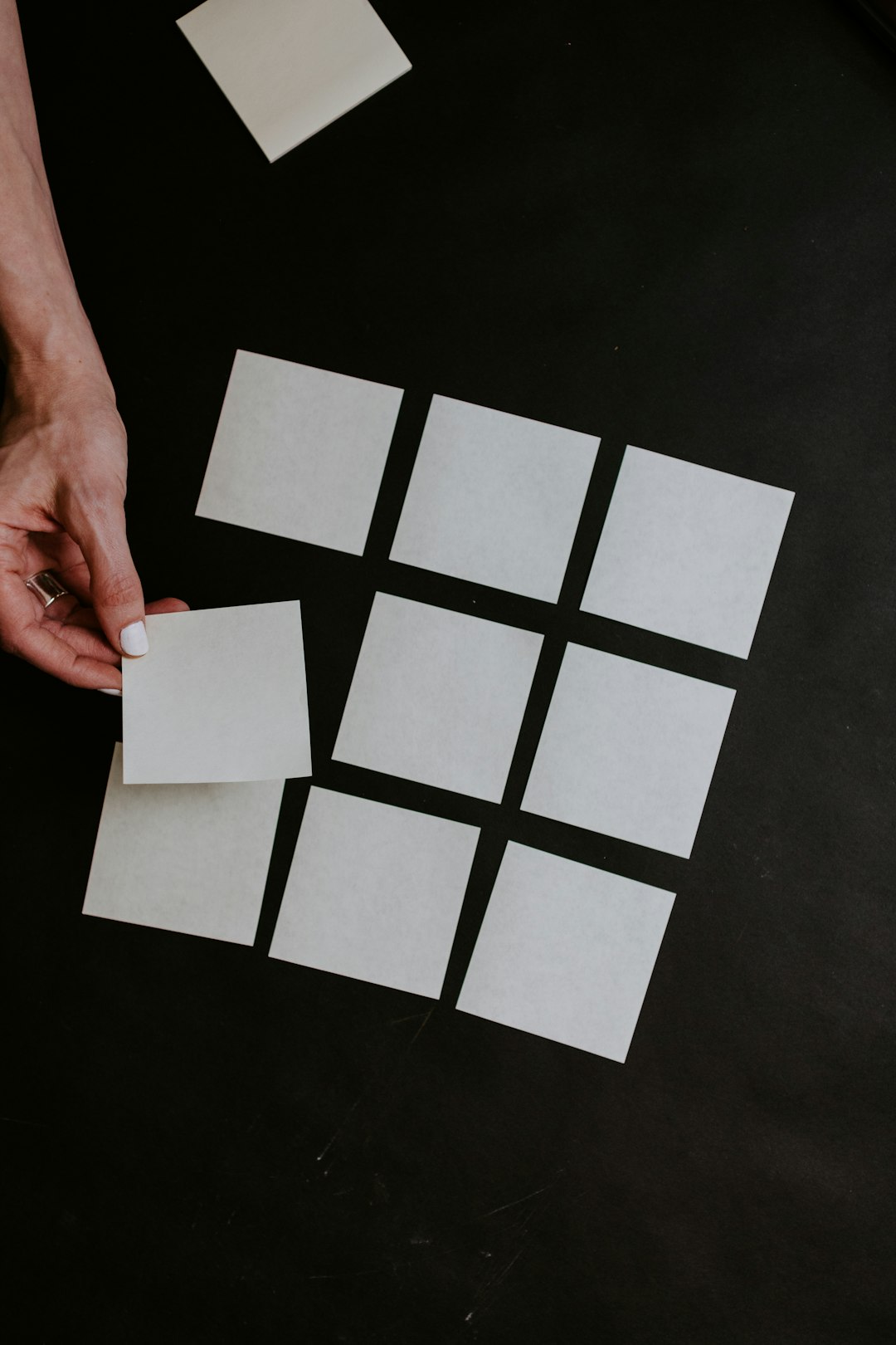 person-holding-white-and-black-checkered-card-abkfxgob-re